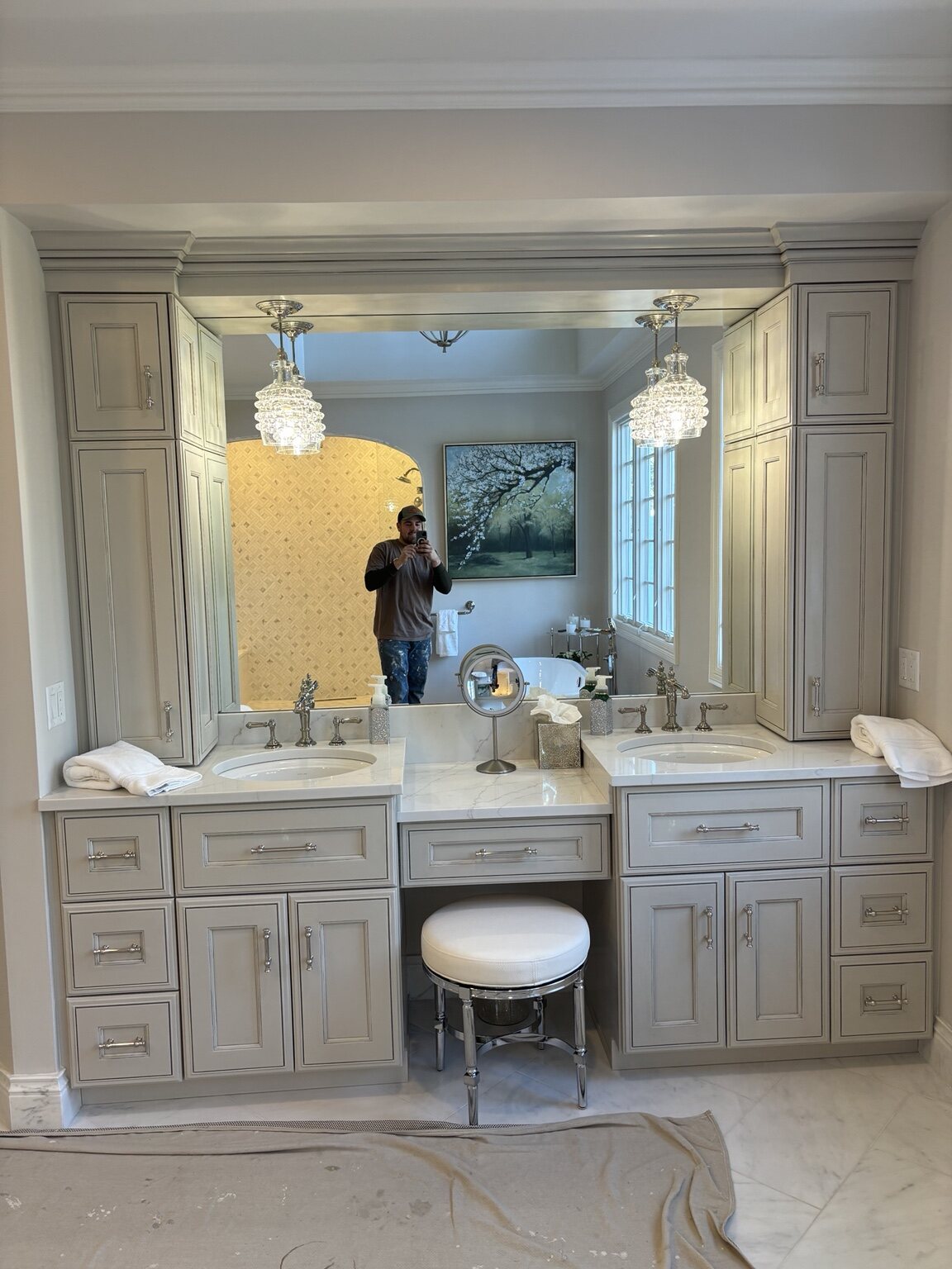 Custom double vanity with a central makeup desk and full-height framed mirror