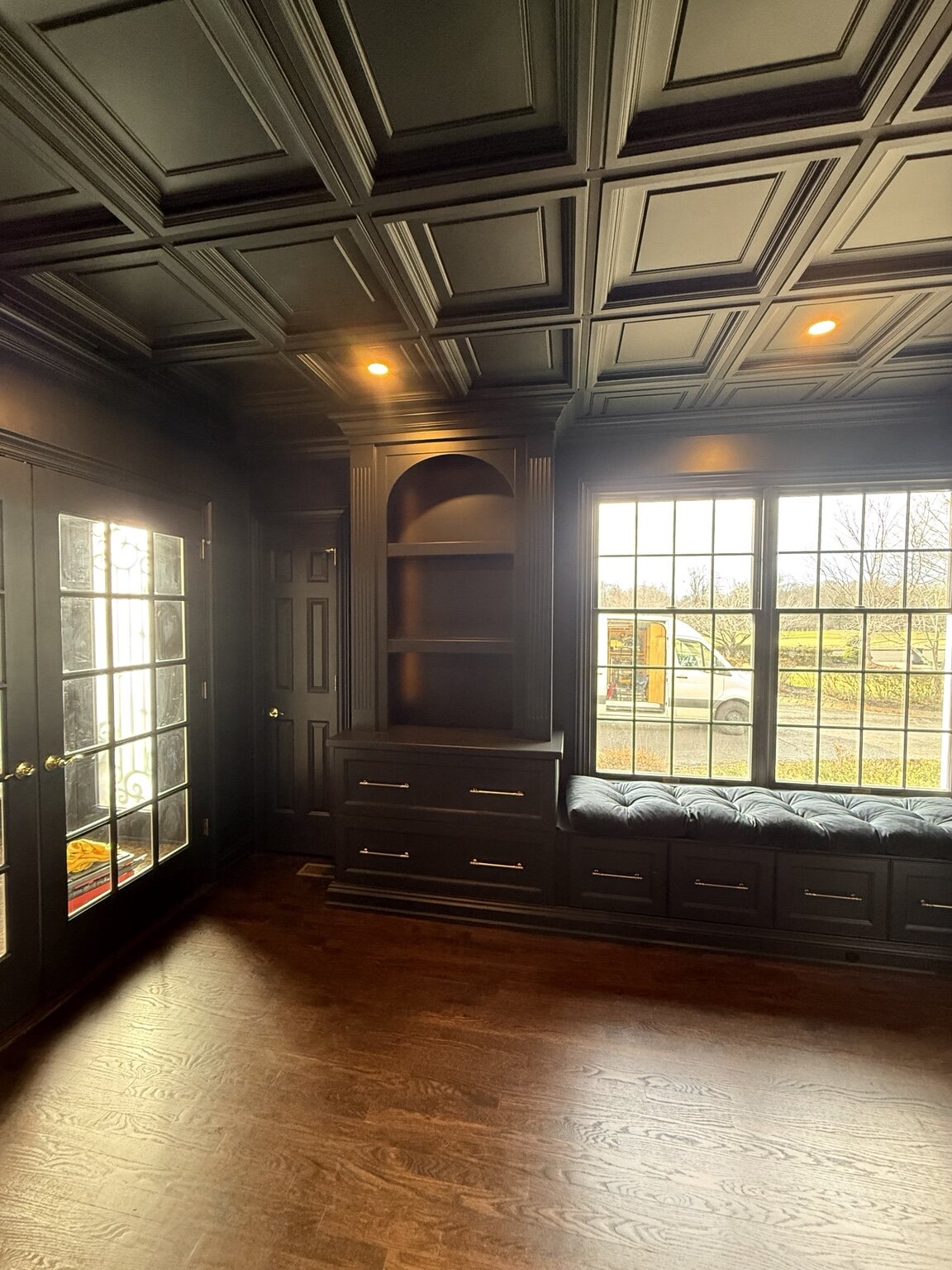 Custom library window seat with drawers and surrounding cabinetry
